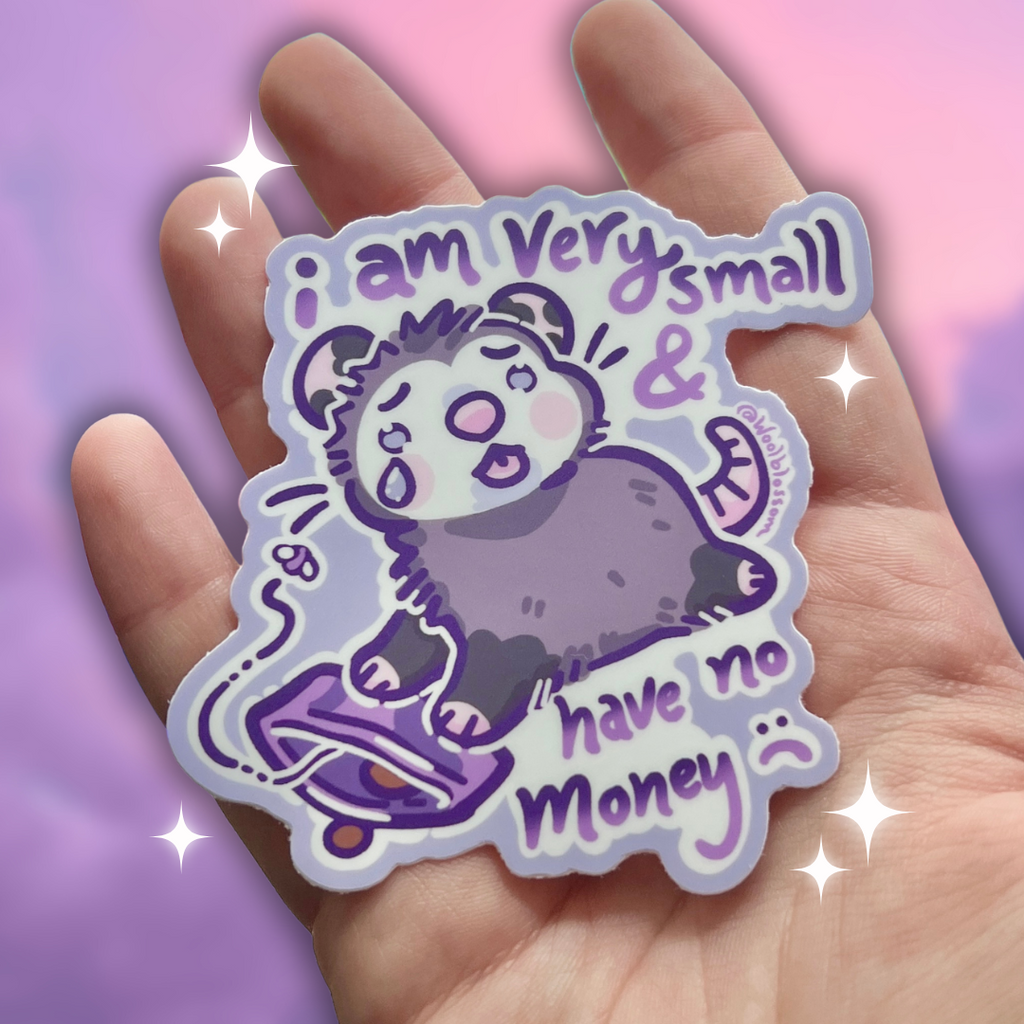 hand holding Sticker of a sad opossum with text that says "i am very small and have no money"