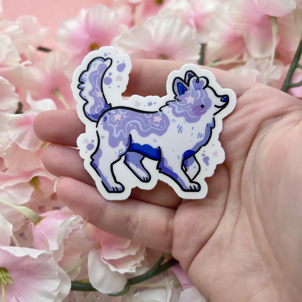 a sticker of a collie but the pattern is white with purple paint like splotches