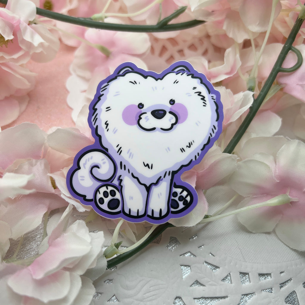 A sticker of a silly white dog with a haircut that makes its head look like a heart