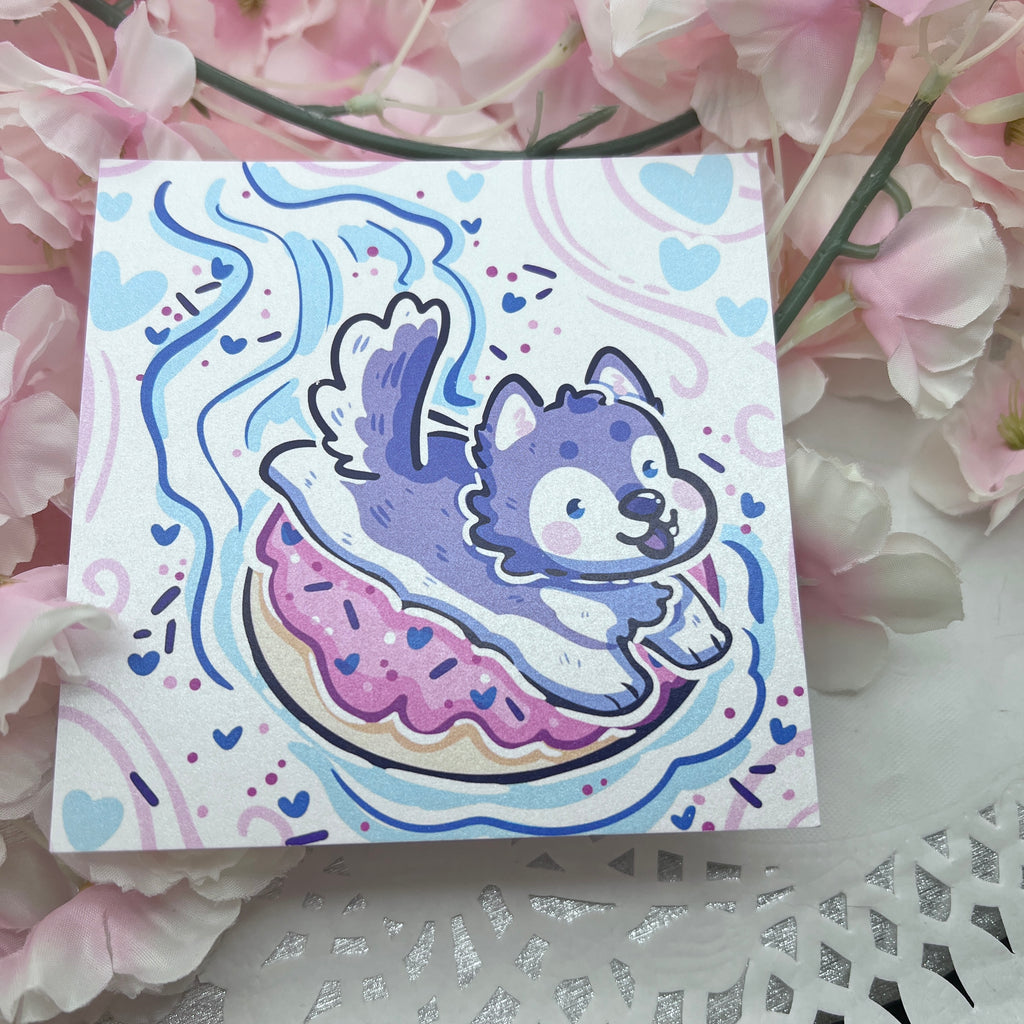 A print of a husky sledding on a doughnut 