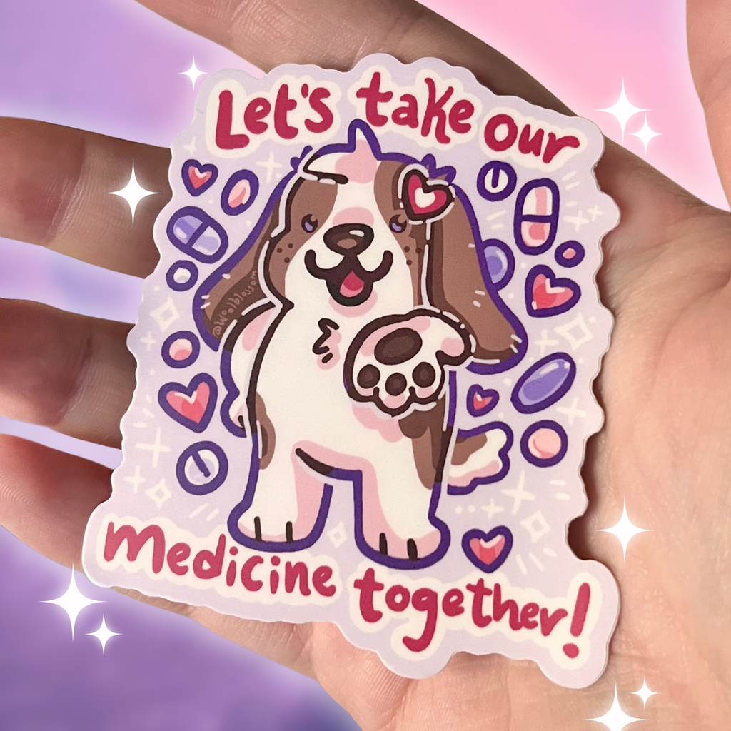 Sticker with a dog illustration and text 'Let's take our medicine together!' held in a hand.