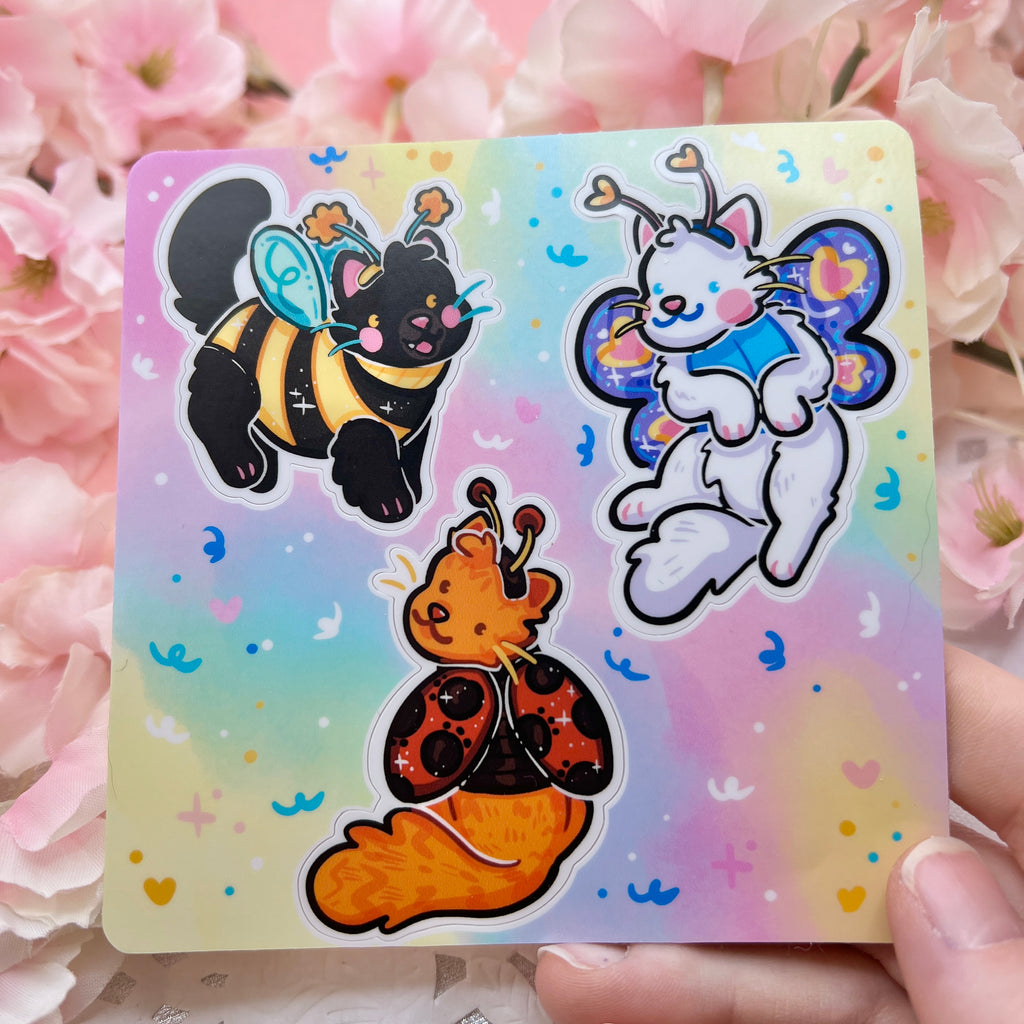 A sticker sheet of three different cats in bug themed costumes 