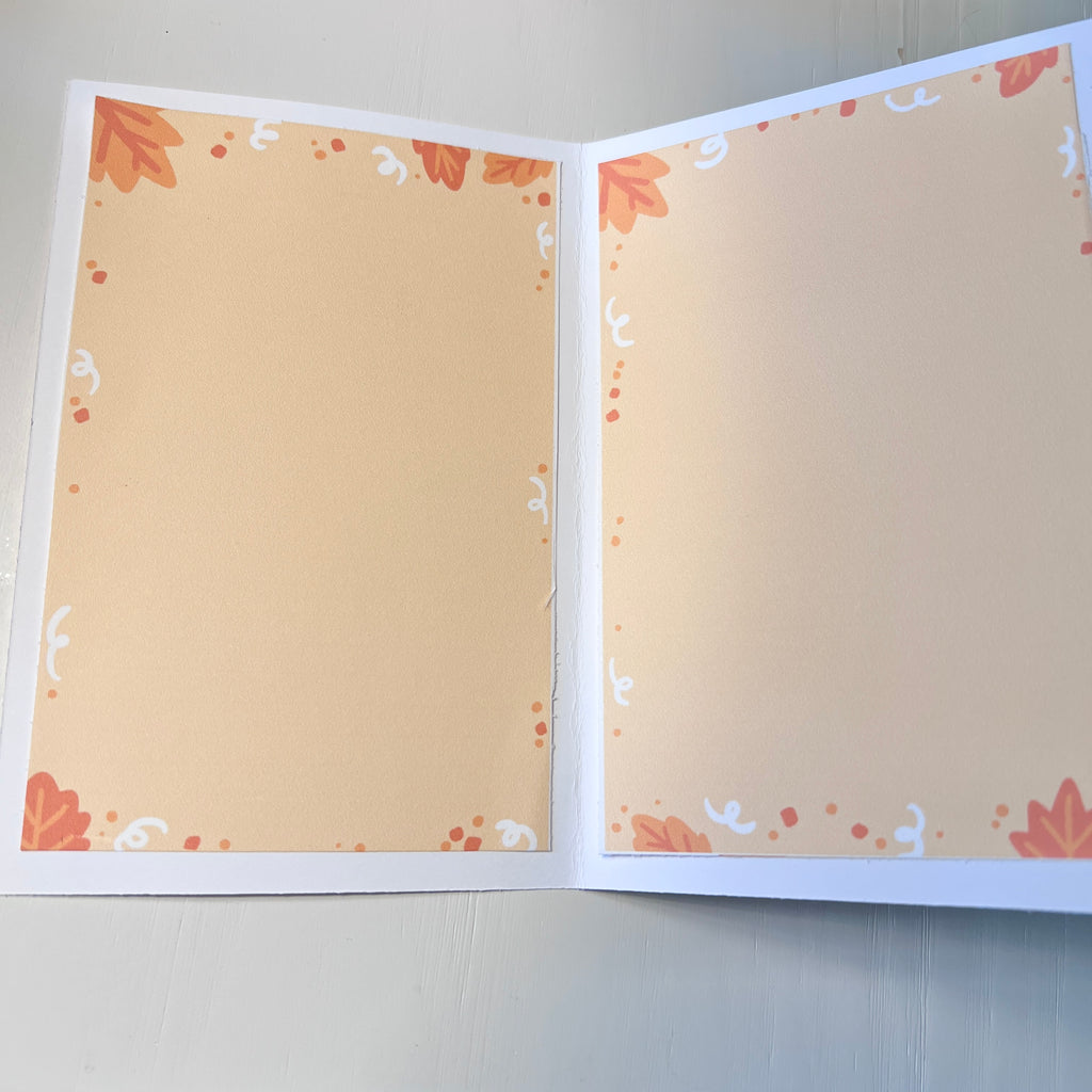 Open card with decorative pages on a plain background