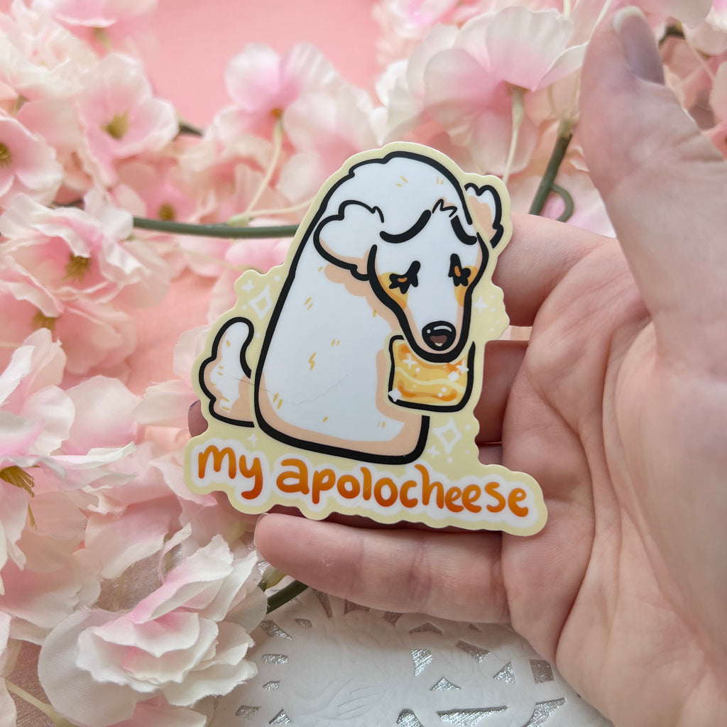 A sticker featuring a VERY sorry borzoi puppy offering a simple slice of cheese to say sorry with text that says "my apolocheese"