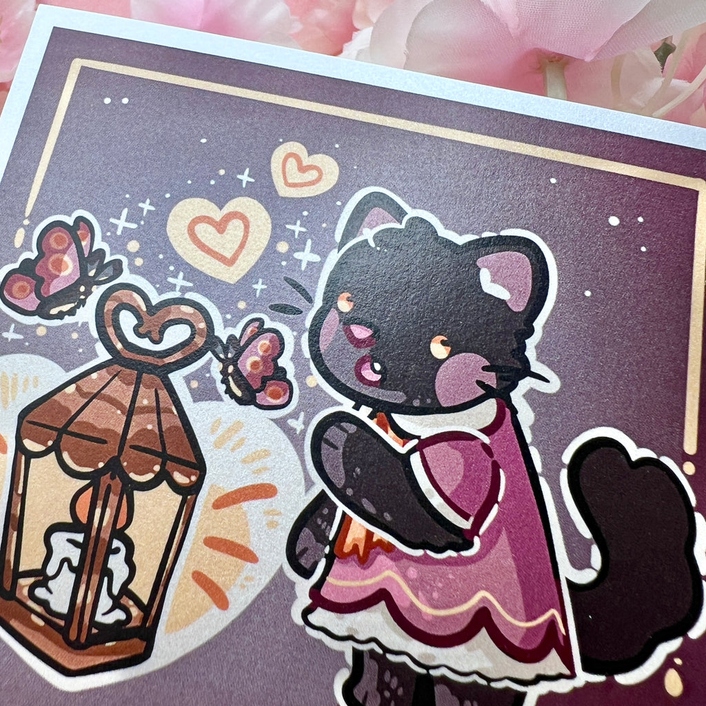 A print of a black cat in a dark rose pink dress reaching out in wonder at a lantern, moths around it, and a heart shape glow