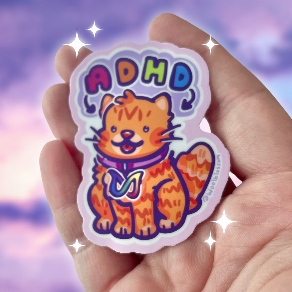 A sticker of an orange cat with text pointing at him that says "adhd"