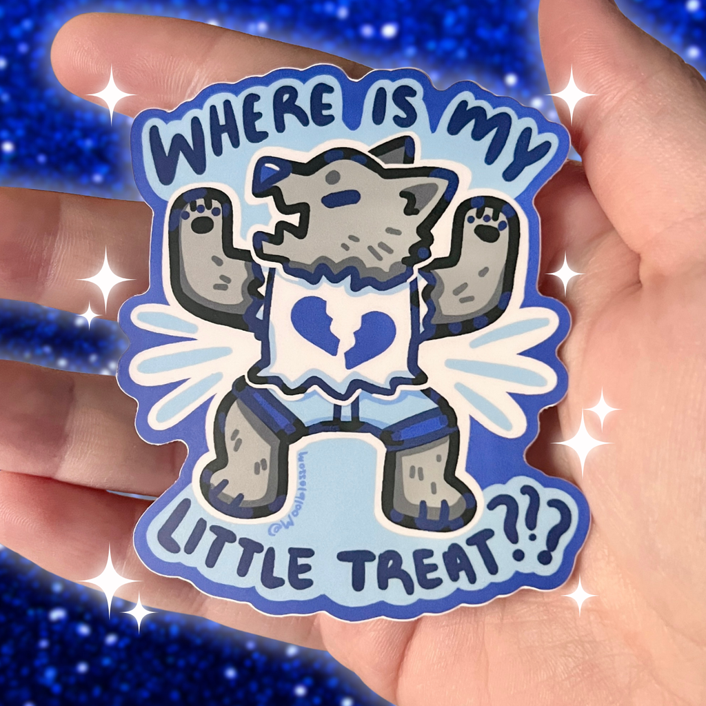 Sticker with a cartoon wolf and text 'WHERE IS MY LITTLE TREAT???' held in a hand against a blue glittery background.