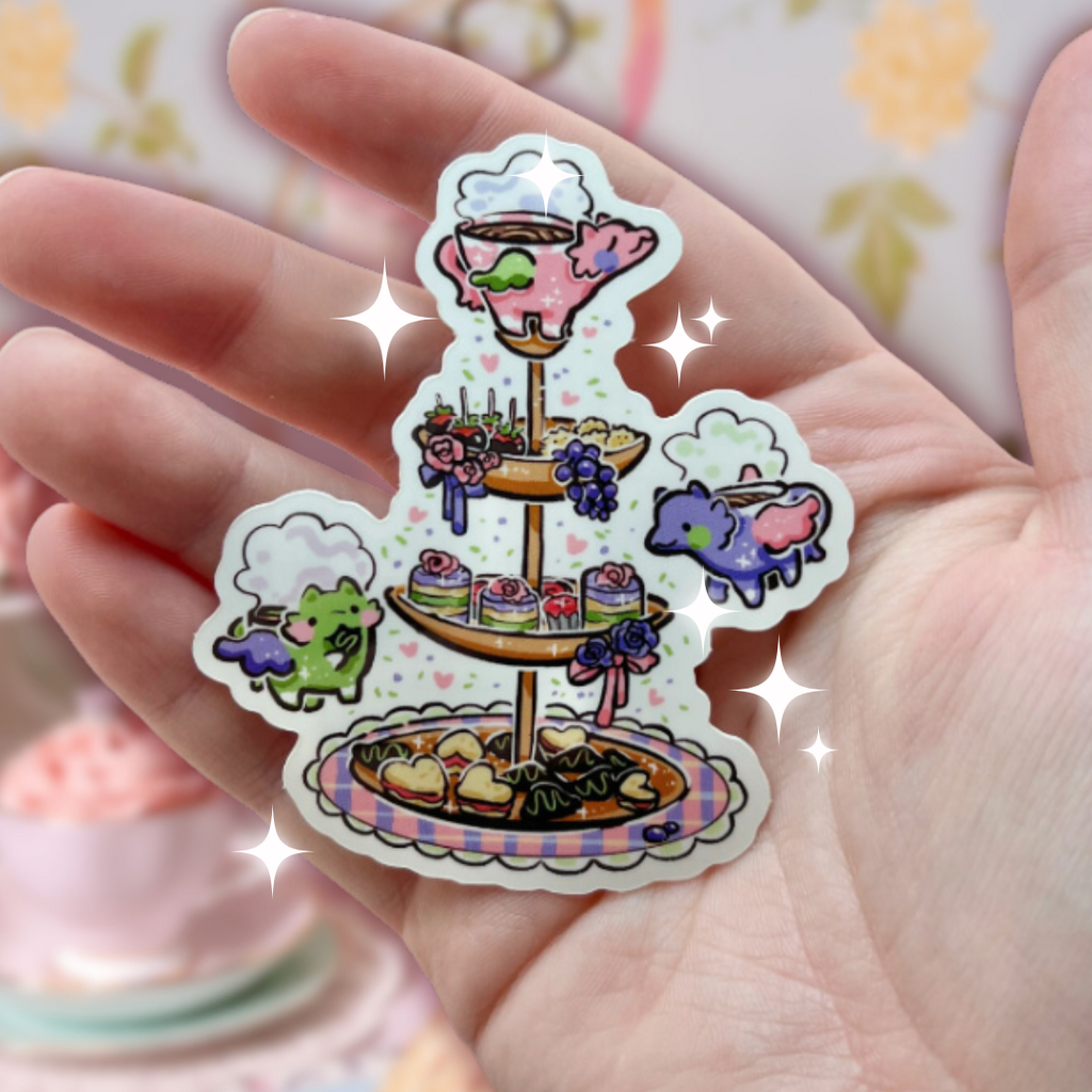A sticker of a tiered selection of tea finger foods with colorful tea cup dragons flying around it
