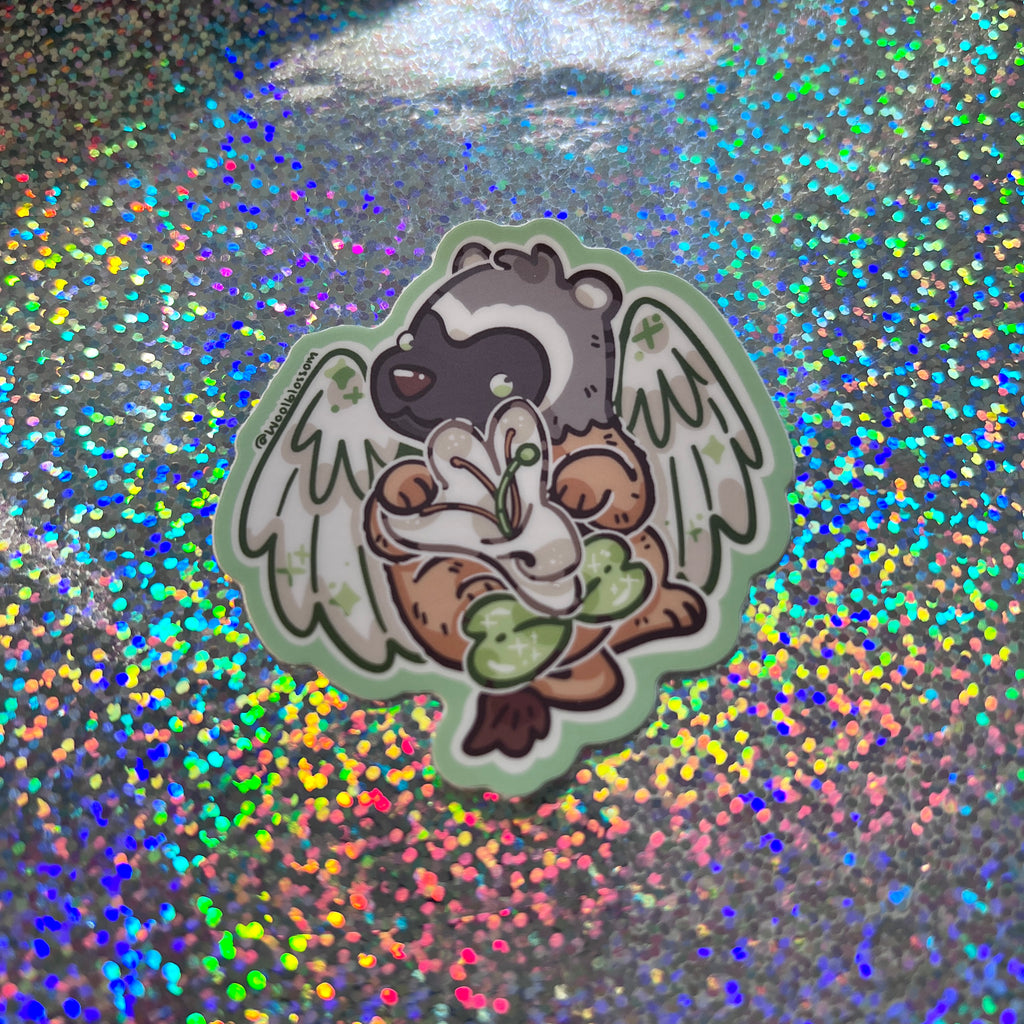 a sticker of a badger gryffin holding a honeysuckle on a glittery background