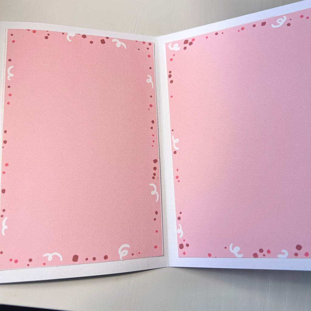 Open card with decorative pages on a plain background