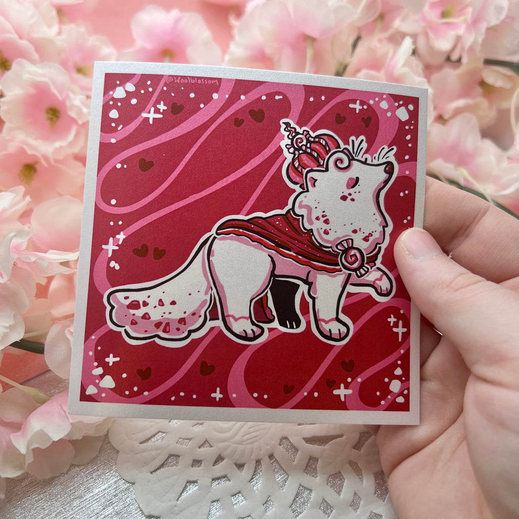 A print of a white fox with red specks, red robe, and red peppermint crown