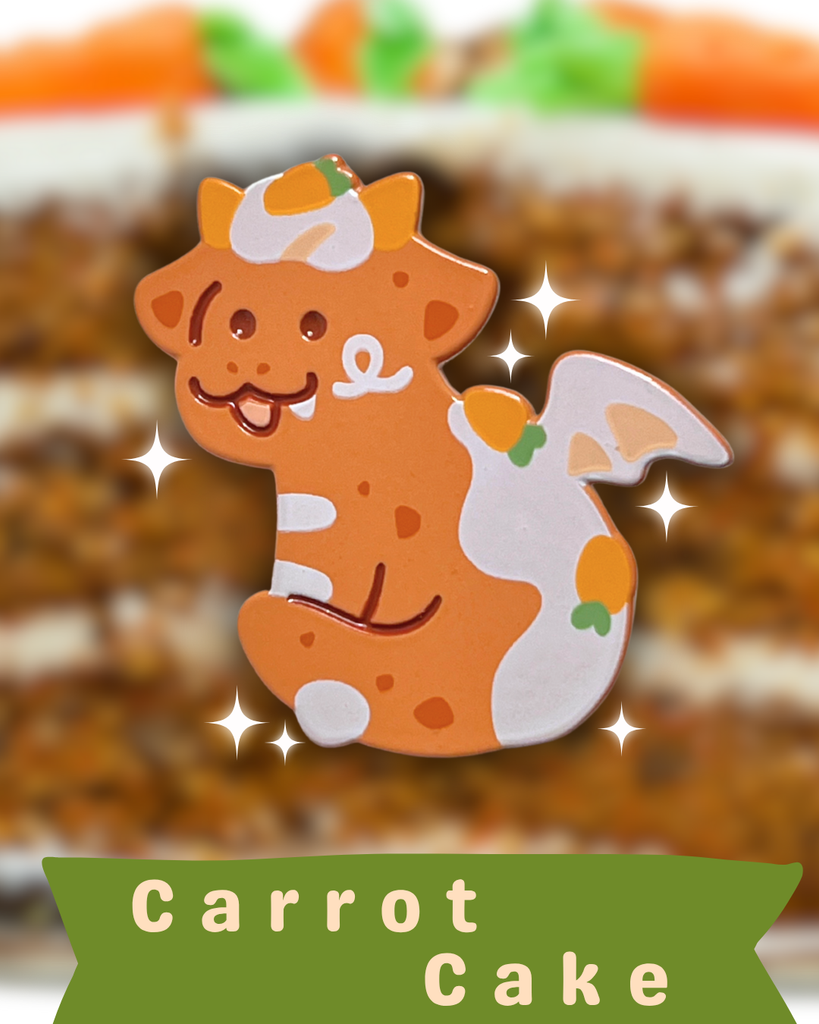 Enamel pin of a carrot cake dragon on a carrot cake with 'Carrot Cake' text below.