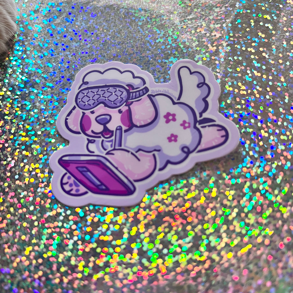  a colorful sticker of a cartoon dog with sleep mask on drawing on an ipad, against a glittery background.