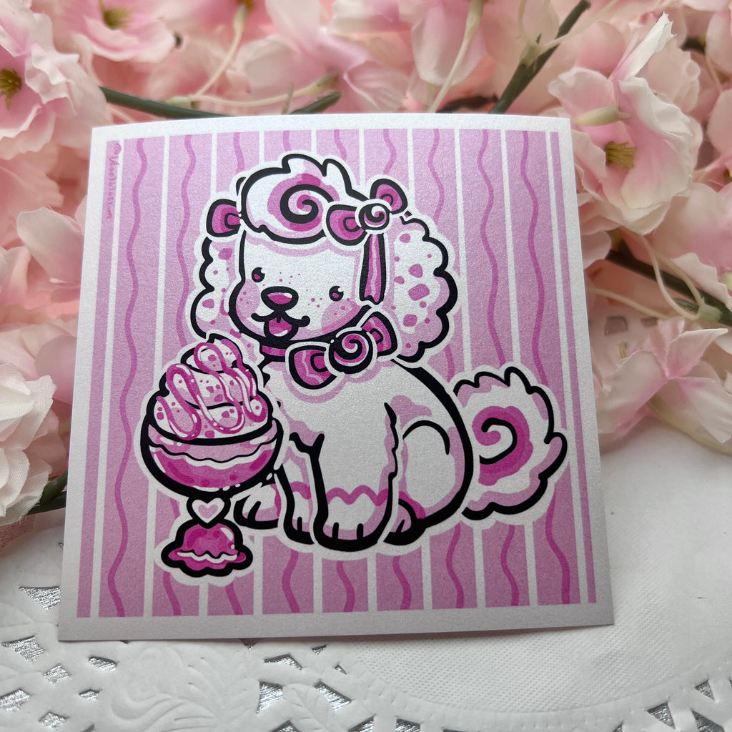 A print of a white puppy with pink accents and bows eating ice cream