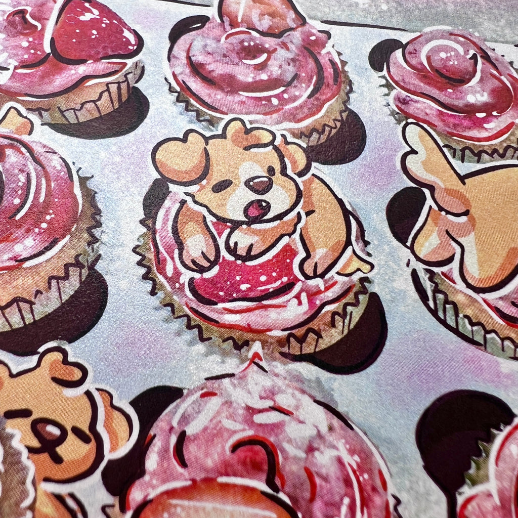 A print that is a draw over of a box of strawberry cupcakes, the draw over adding glitter and some golden puppies napping on and eating them