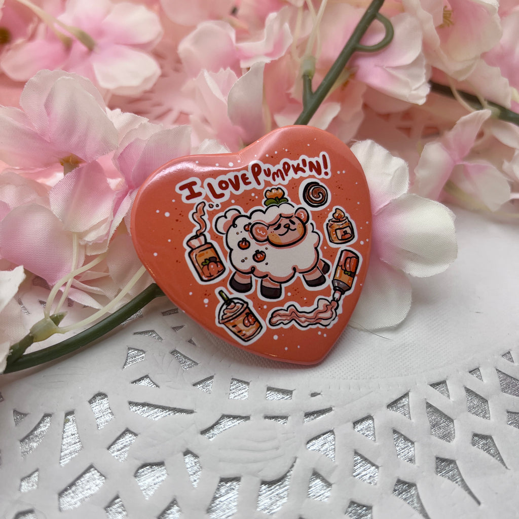 A button of a sheep with text that says "i love pumpkin!" and floating pumpkin themed items (candle, cofffee, etc.) all in a heart