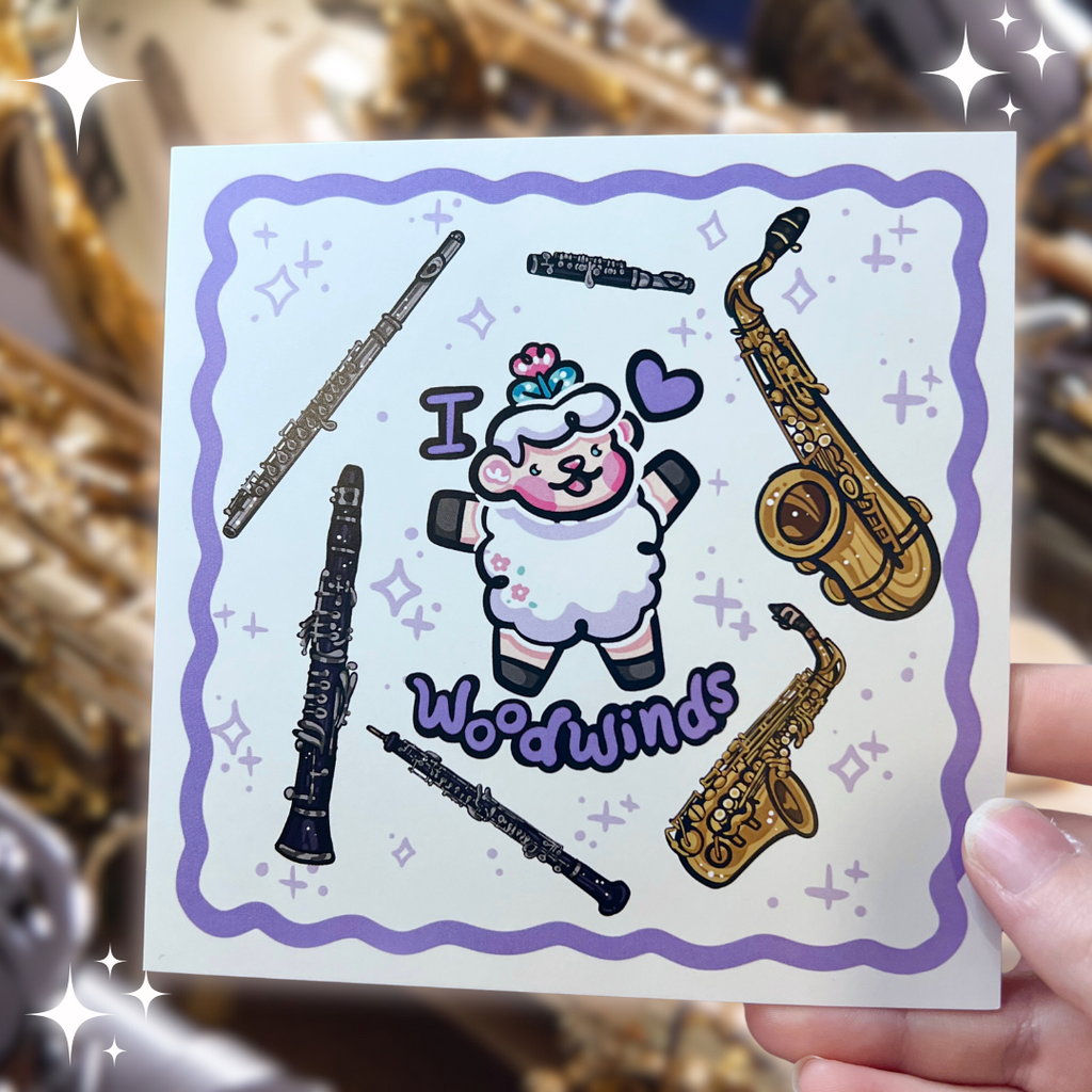 a print of a sheep with the text "I heart woodwinds" and six instruments floating around them (flute, piccolo, tenor sax, alto sax, oboe, clarinet)