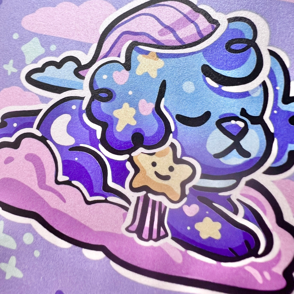 A print of a puppy with a bedtime cap, blue skin, and star bow on a pink cloud in a blue sky