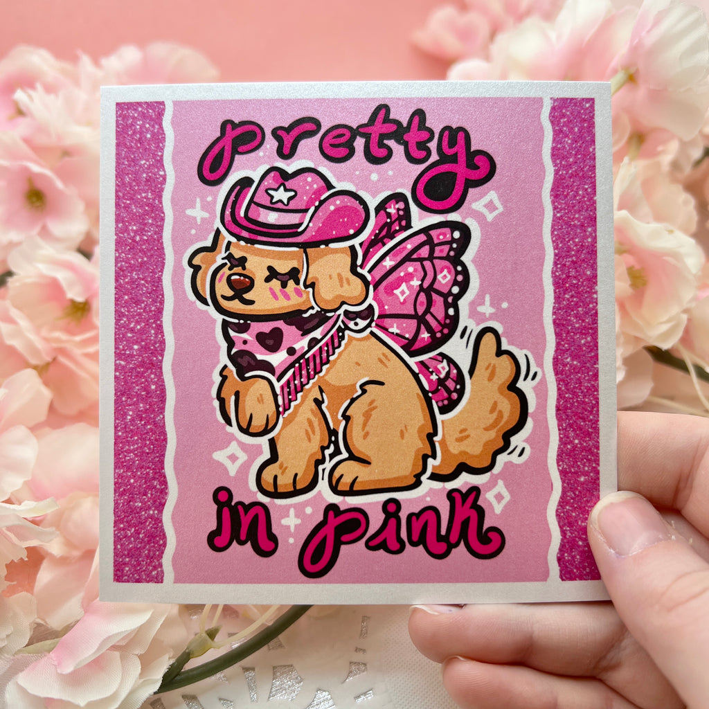 a pink of a golden retreiver with a pink cowgirl hat, boots, and dark pink fairy wings and text that says "pretty in pink"