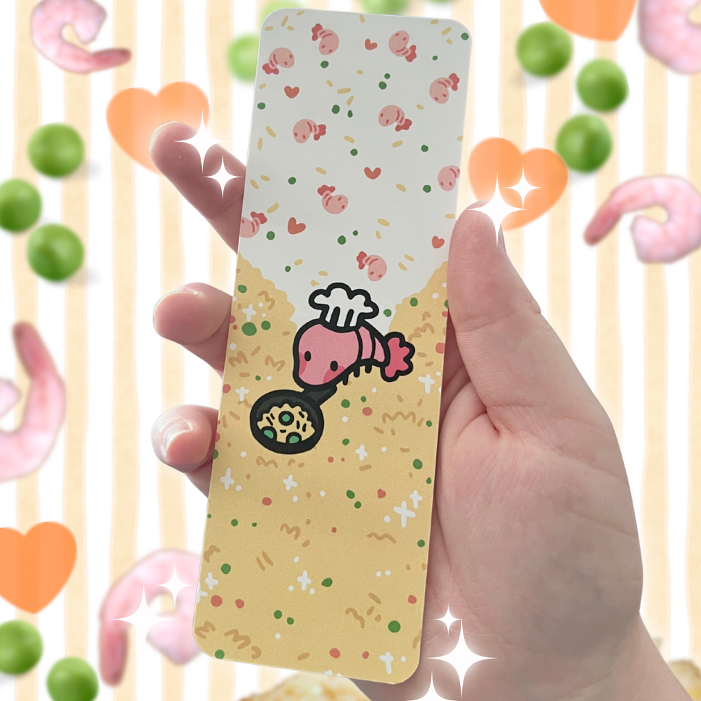 hand holding a bookmark of art of a shrimp frying rice