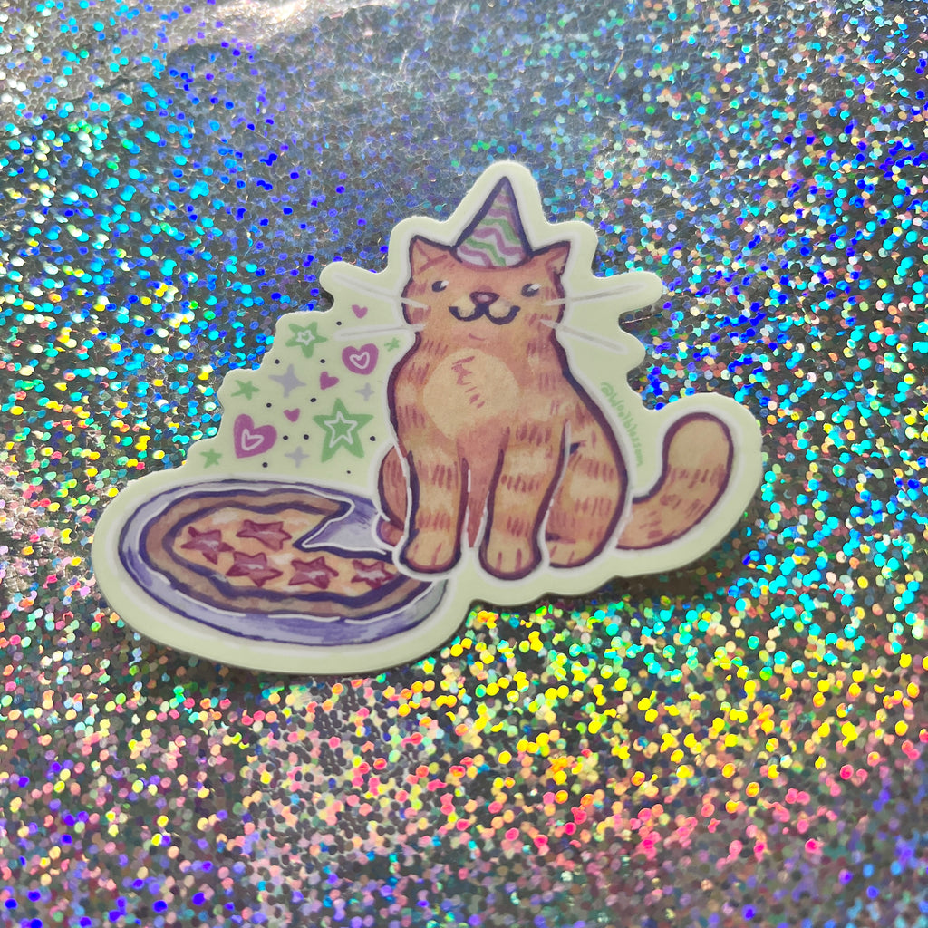 Sticker of a cat with a party hat and pizza on a glittery background