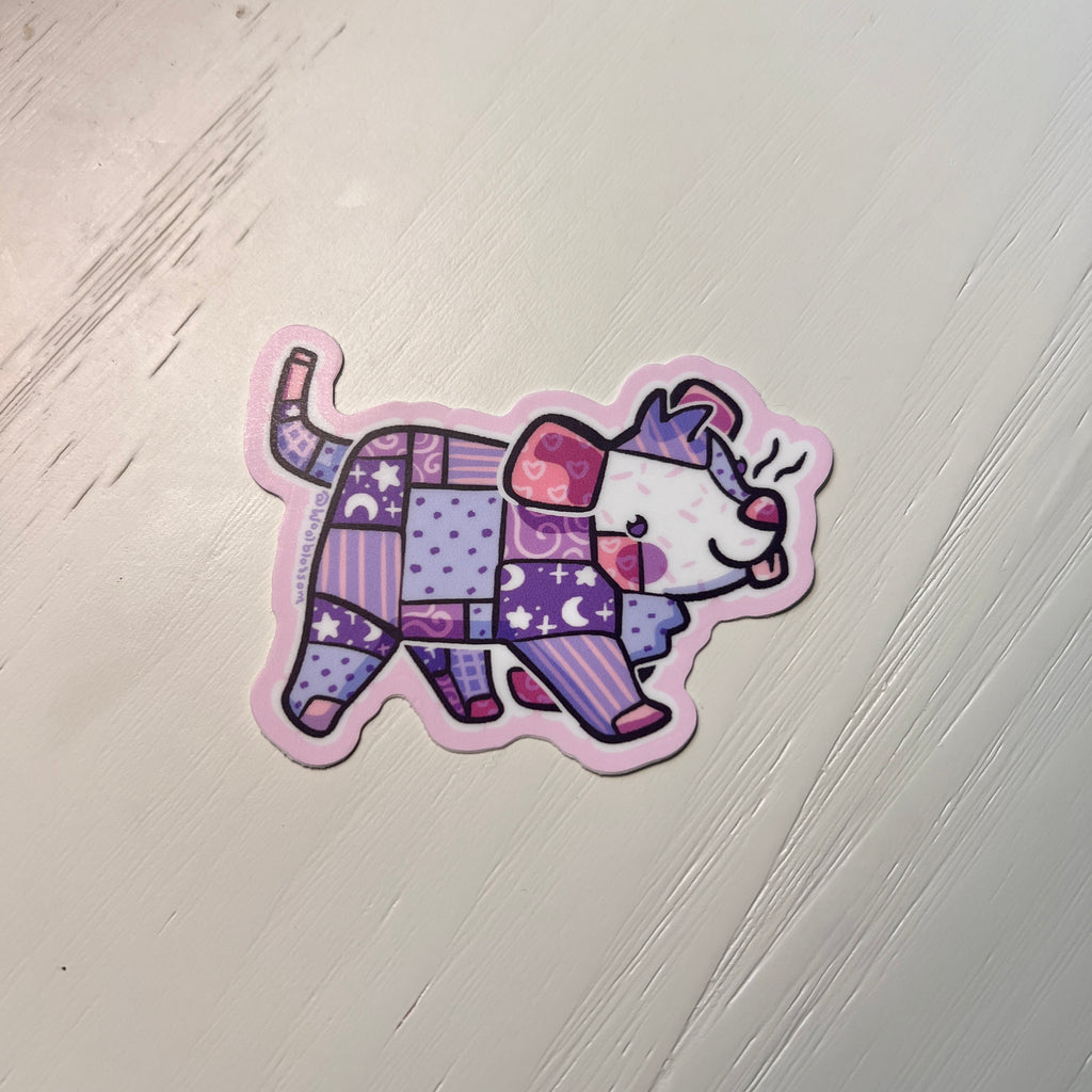 Sticker of a colorful patchwork opossum design on a white background