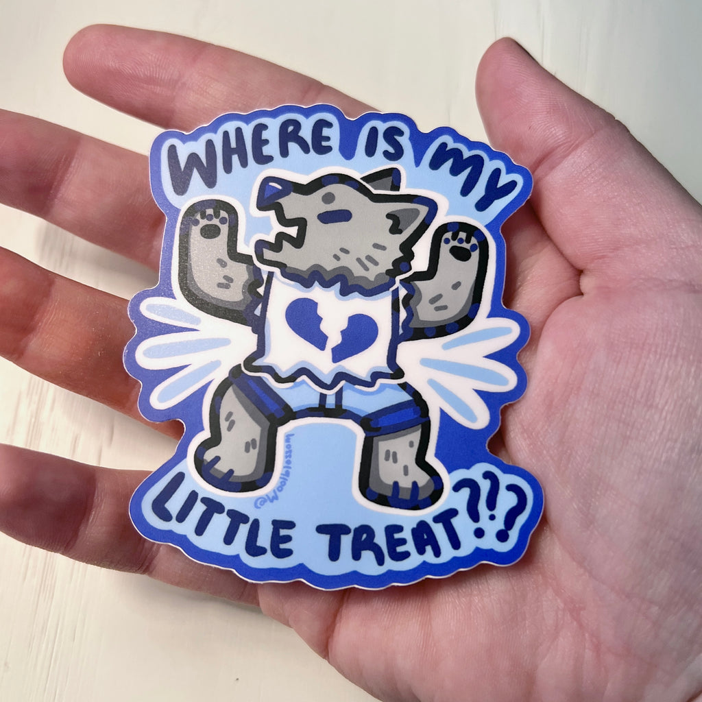 Sticker with a cartoon wolf and text 'WHERE IS MY LITTLE TREAT???' held by hand