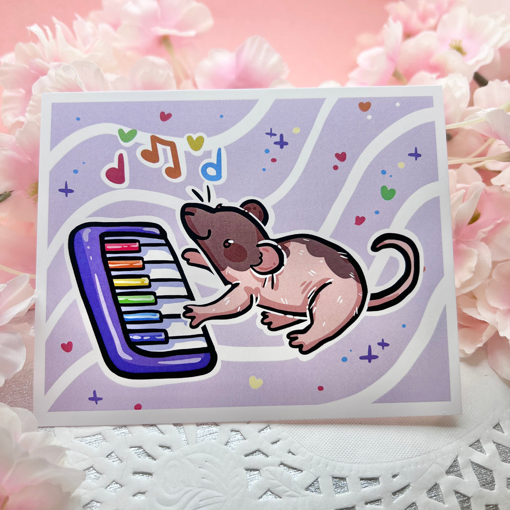 A print of a brown/pink mostly hairless rat playing a rainbow piano