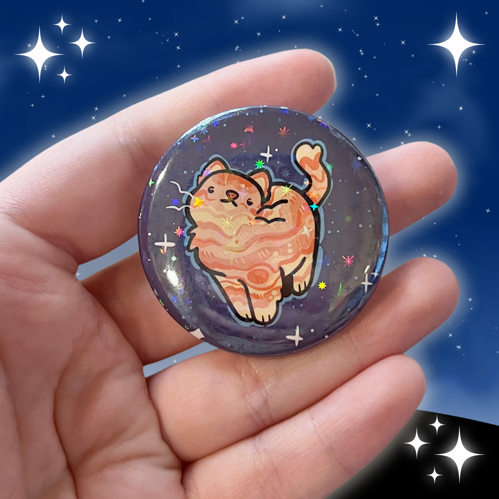 a button of an orange cat with markings like jupiter's