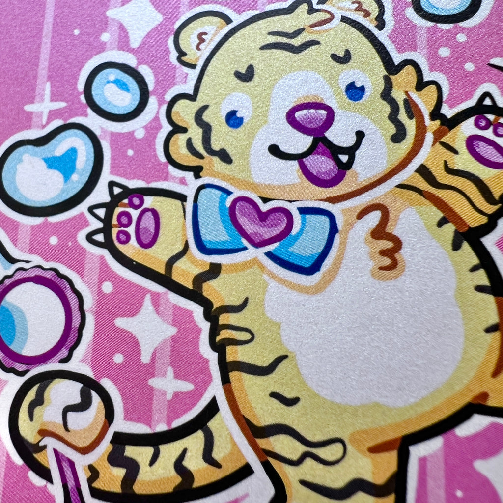 A print of a cute tiger balancing on a ball, bubble wand in tail, reaching up and poking the bubbles with his claws. Pink aesthetic overall.