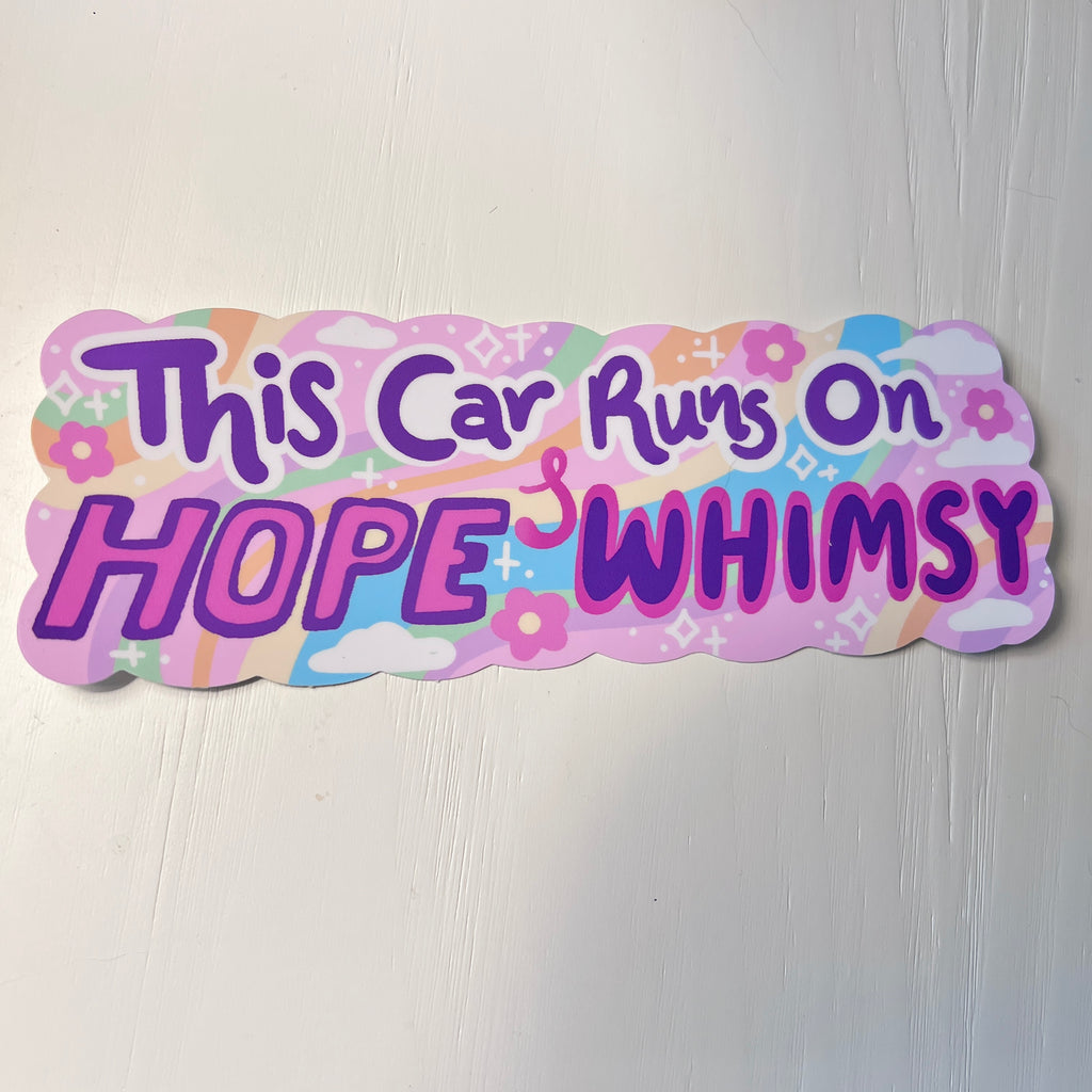 Decorative bumper sticker with colorful text 'This Car Runs On HOPE & WHIMSY' on a white background