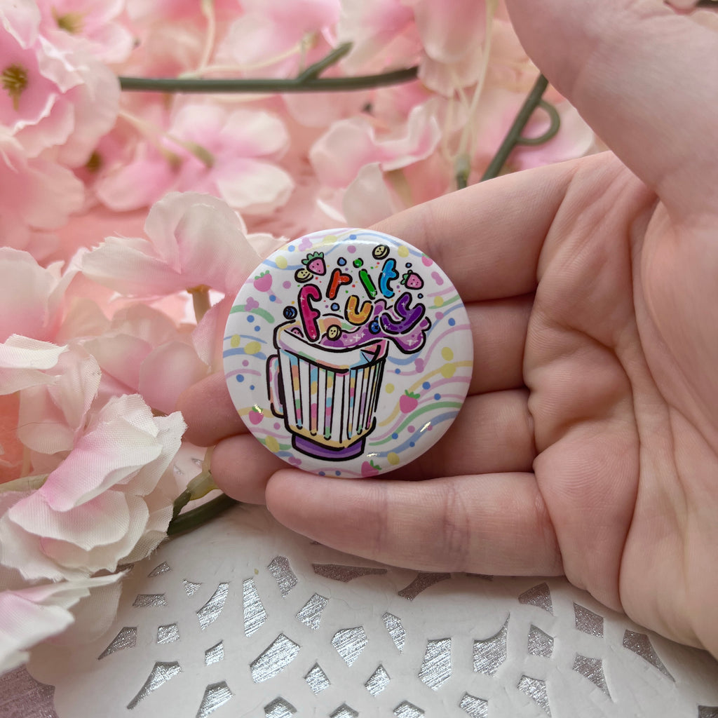 A button of a blender with fruit floating out and bubble rainbow text that says "fruity"