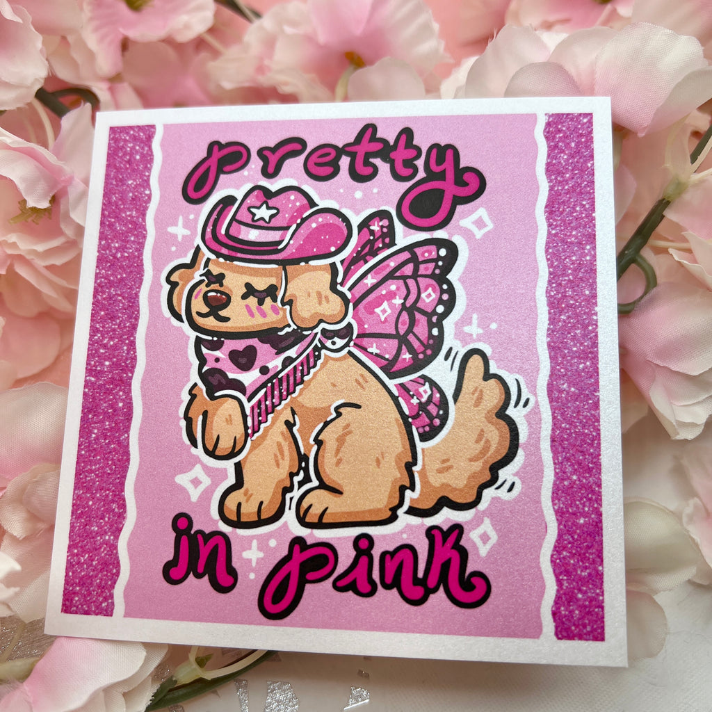 a pink of a golden retreiver with a pink cowgirl hat, boots, and dark pink fairy wings and text that says "pretty in pink"