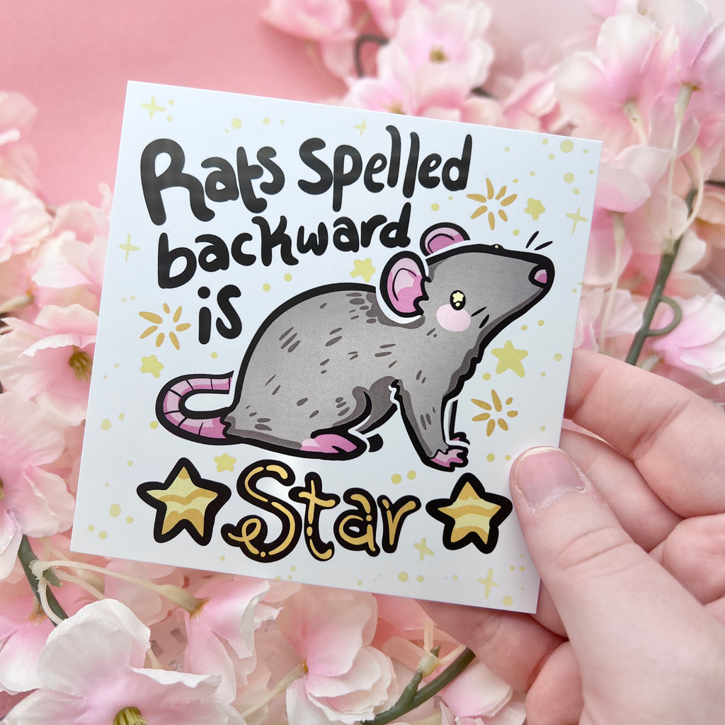 a print of a gray rat with the text "rats spelled backward is star" and gold star accents