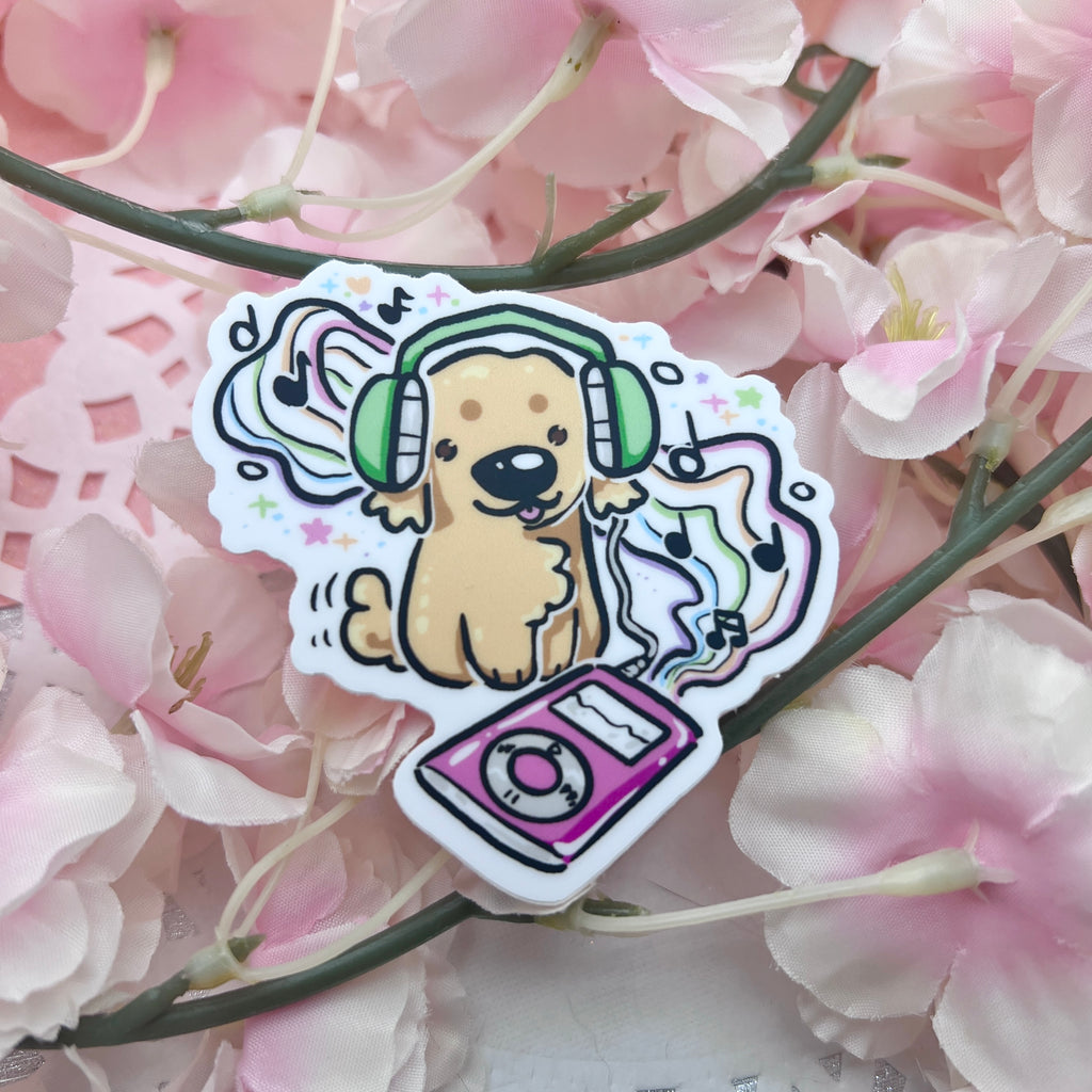 A sticker of a golden retriever with headphones on listening to a retro music player with rainbow music staff and notes