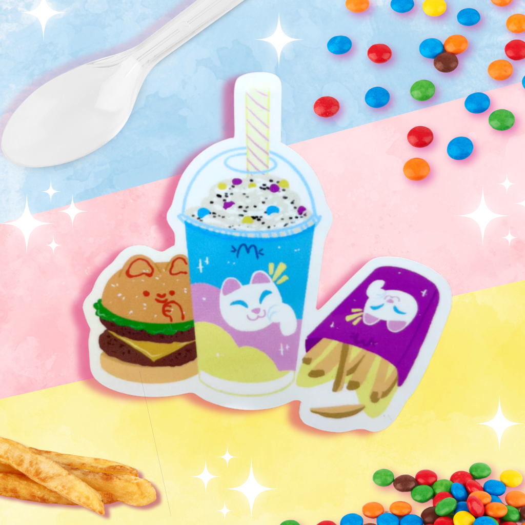 The Meowdonalds ~ Sticker features a cute illustration of a burger, milkshake, and popsicle with cat faces against a pastel background. The scene is surrounded by colorful candies, fries, and a white plastic spoon, creating a whimsical and playful theme—all printed on glossy vinyl for weather-proof durability.