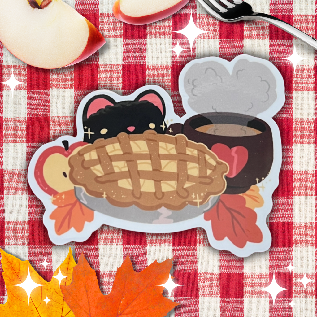 The "Autumn Cat Scene ~ Sticker" features an autumn-inspired illustration of an adorable black cat with pink ears peeking over a lattice-top pie. The sticker is adorned with fall leaves and apples, and also includes a steaming mug with a heart design. Set against a red and white checkered tablecloth, it's the perfect cozy addition for your fall decorations—pure baking inspiration!