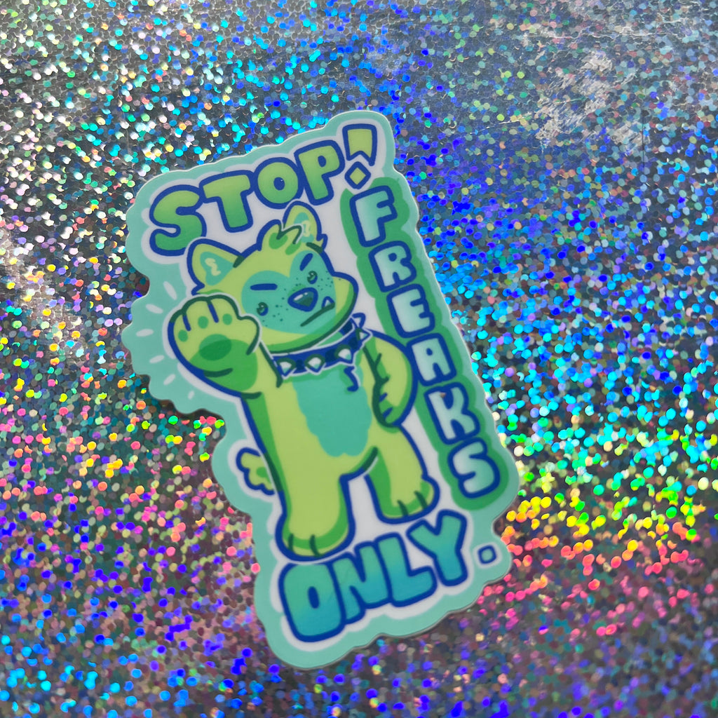 A sticker that has a green puppy holding their hand out with text that says "stop! freaks only."