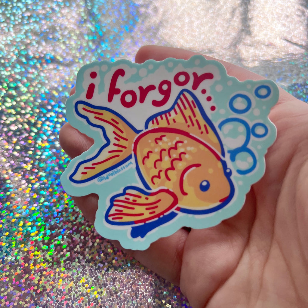 A sticker of a gold fish with text that says "i forgor"