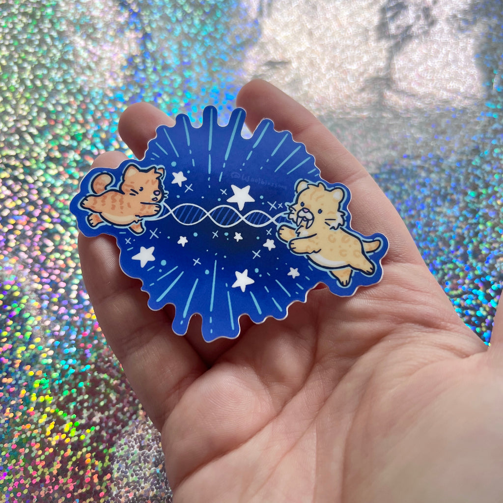 A sticker of an orange cat reaching out to a sabertooth tiger with dna connecting them and stars around