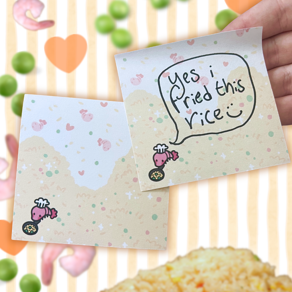 sticky note with 'Yes i fried this rice' hand written and cartoon shrimp, held over a plate of fried rice.