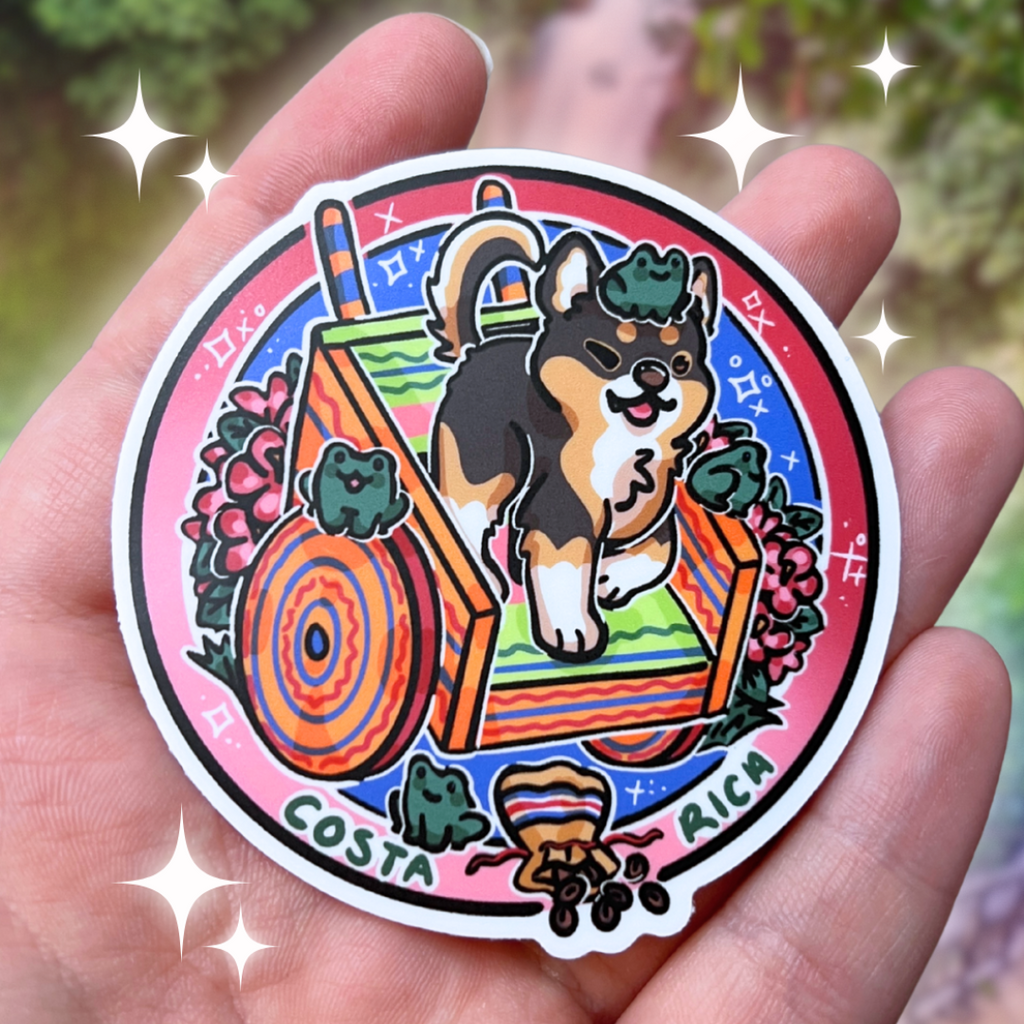 a sticker of a chihuahua on a decorative cart, surrounded by flowers, frogs, and chocolate held in a hand against a blurred natural background