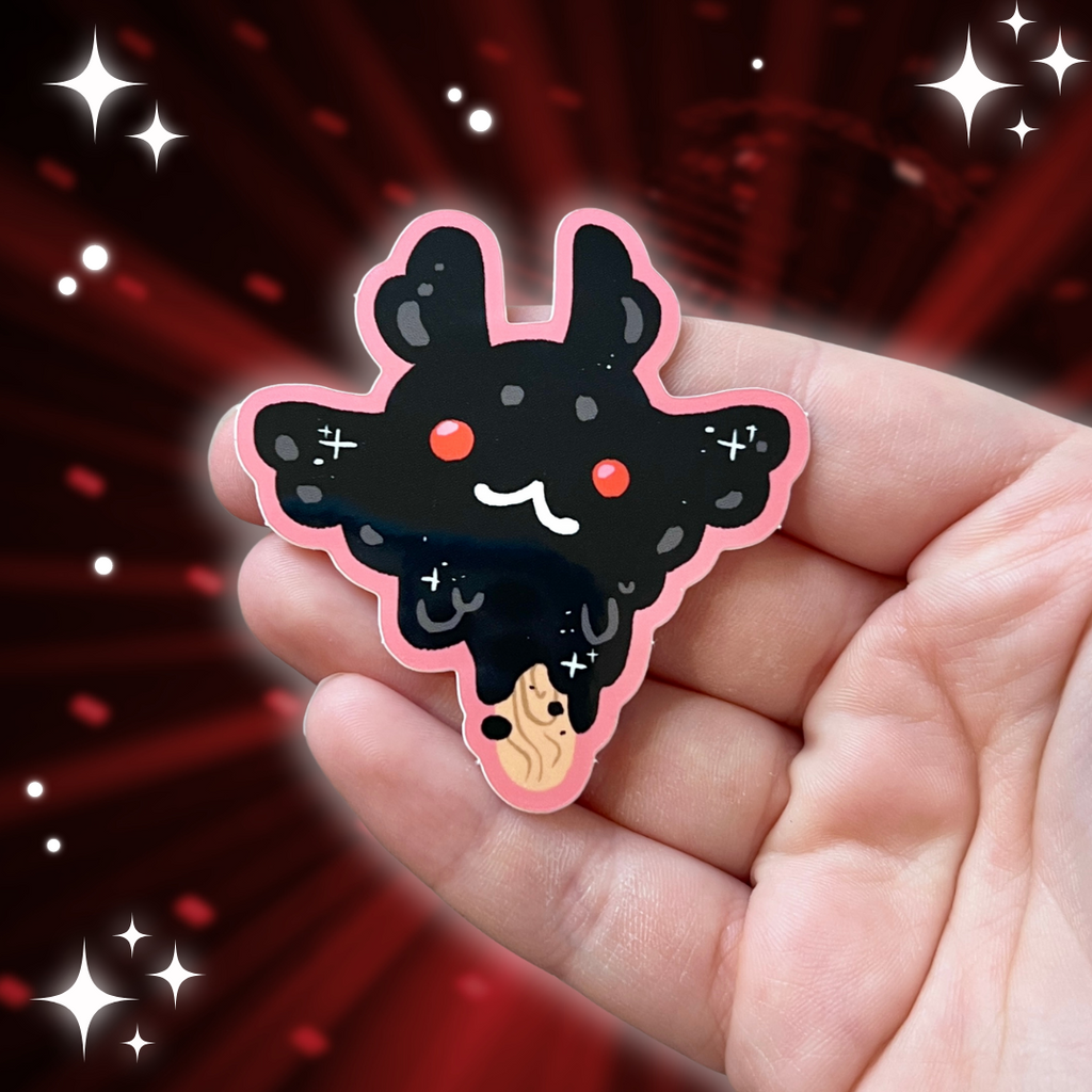 a sticker of mothman as a character popsicle with red gumball eyes