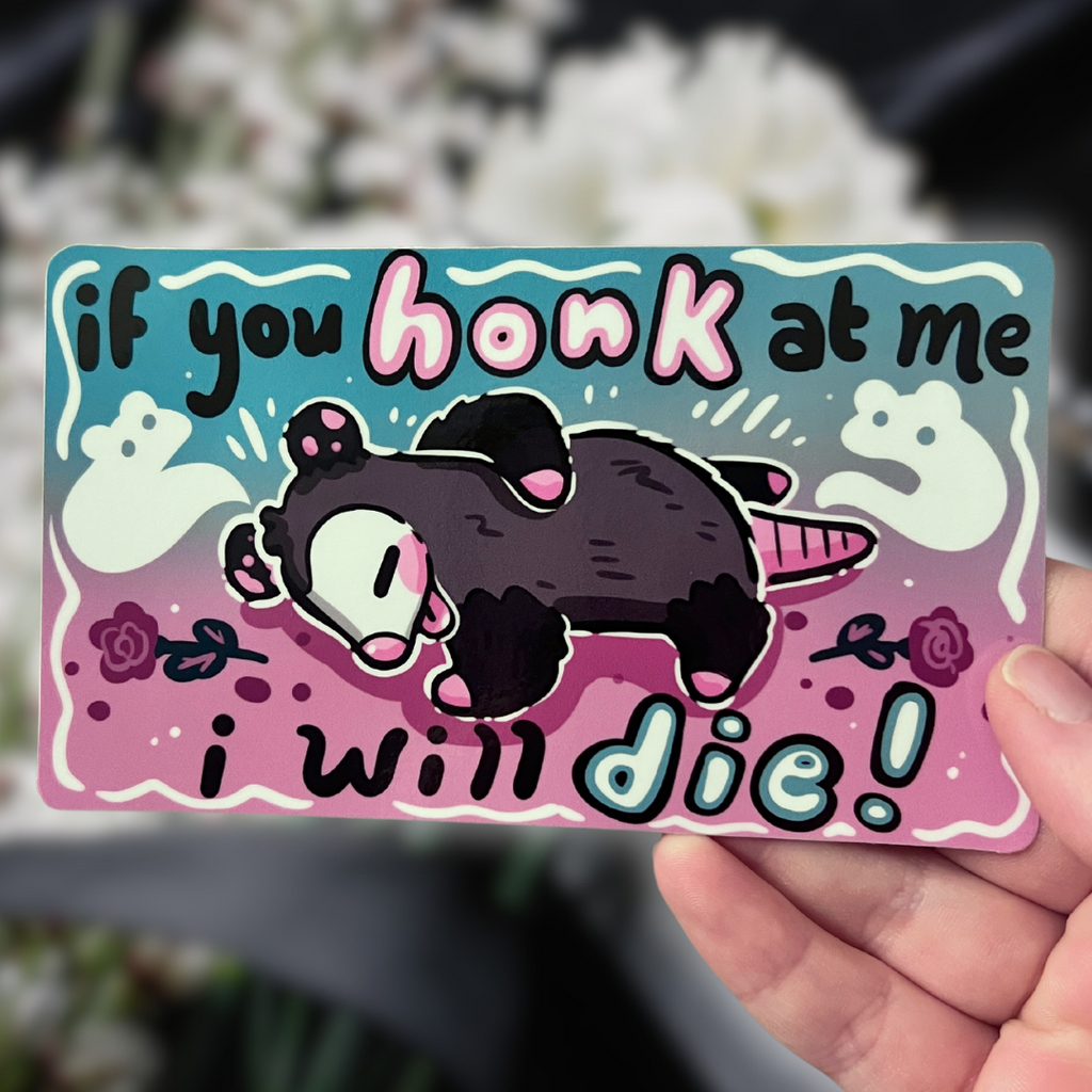 a bumper sticker of a opossum who looks dead, ghosts and flowers around it, with text that says "if you honk at me i will die"