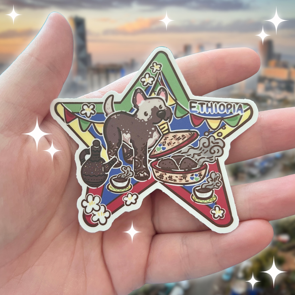 a sticker of a hairless dog eating bread with Ethiopian decorations