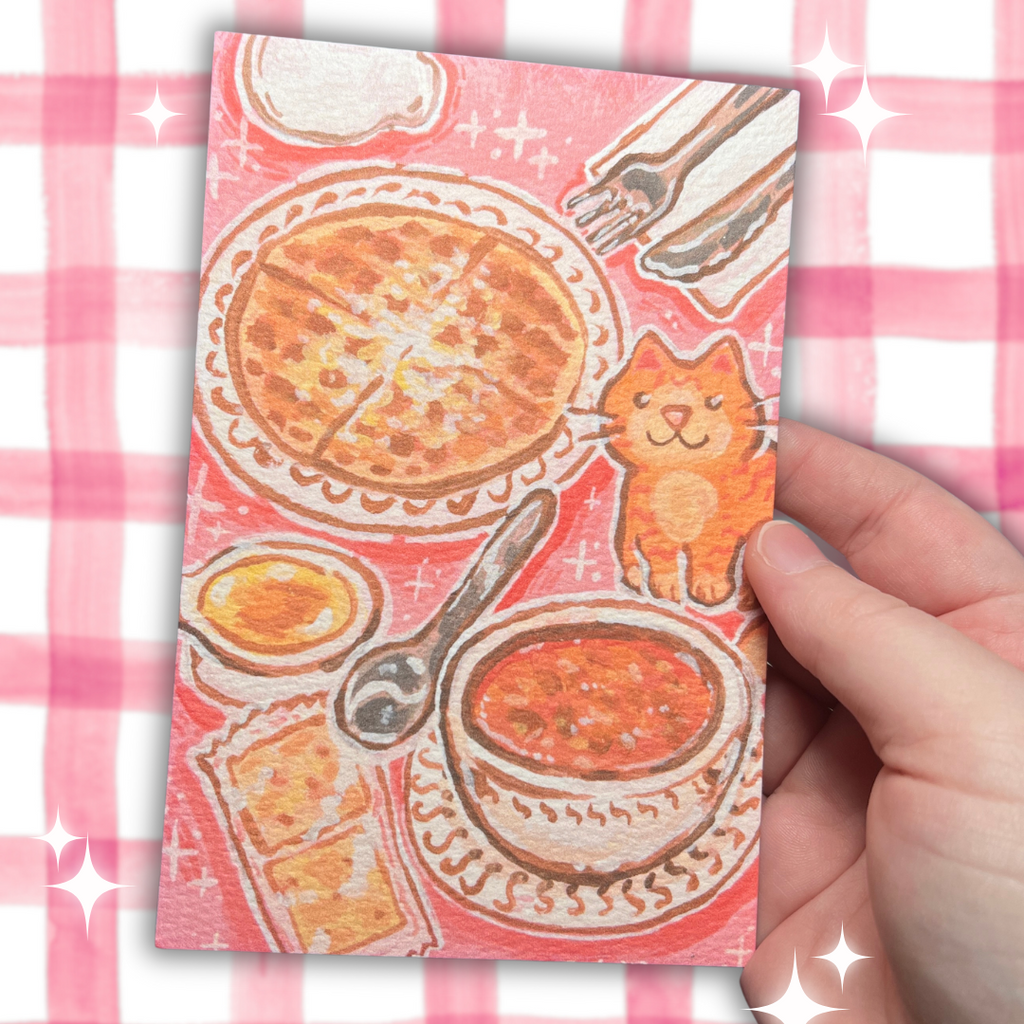 Print of an orange cat eating a lunch of waffle and chili held in a hand against a pink checkered background