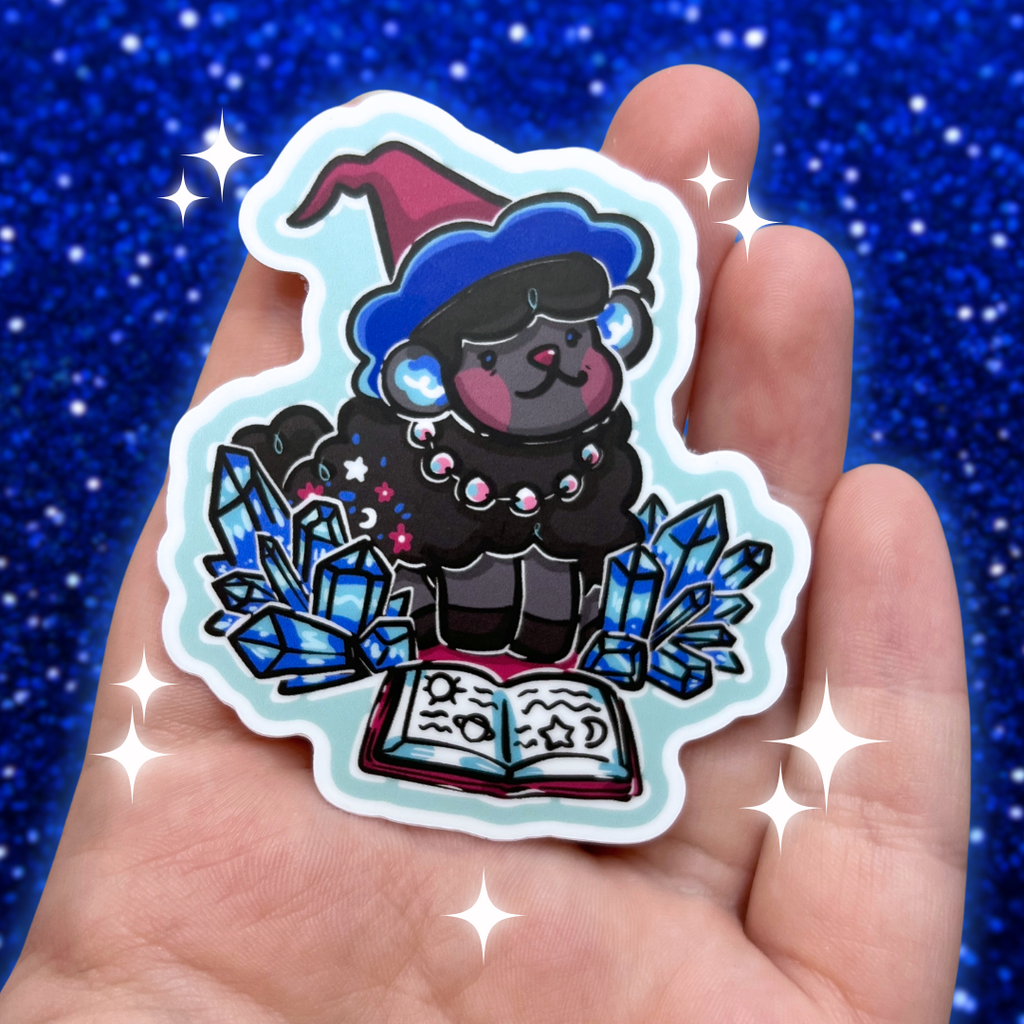 Sticker of a cartoon sheep in a witch outfit with crystals and a book held in a hand against a blue glittery background.