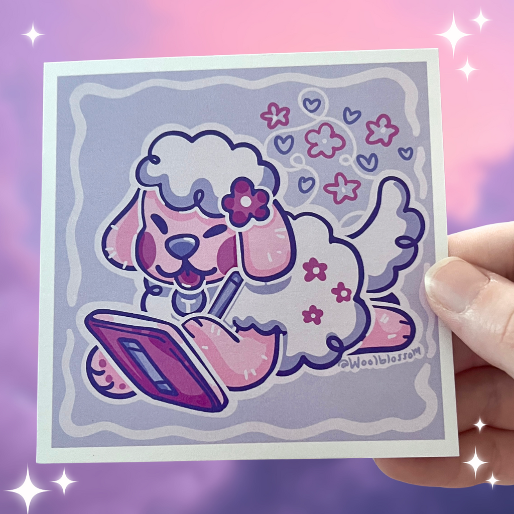 print of a sheep dog drawing on a digital tablet held by a hand on a sparkly purple background