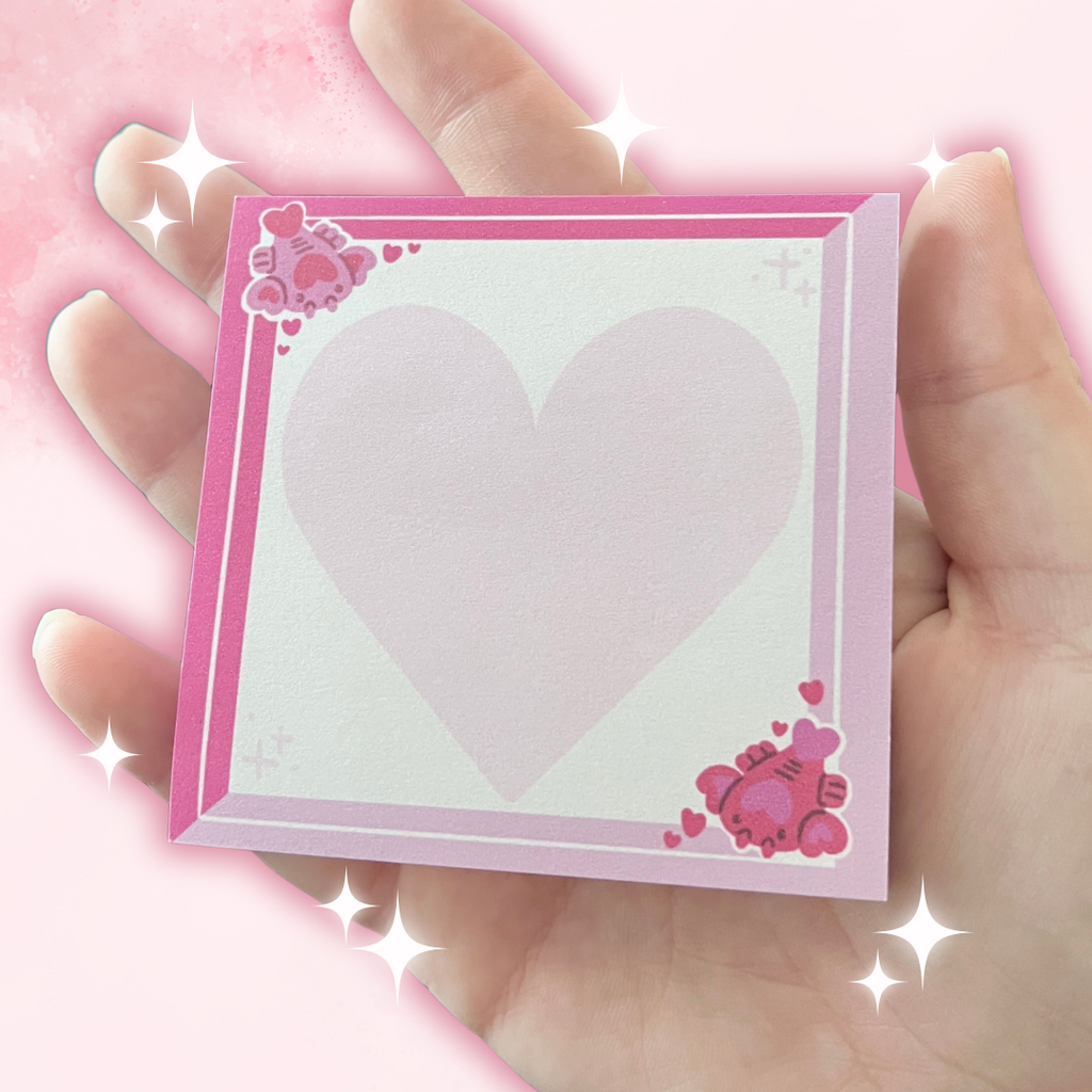 Holding pink sticky notes that have love lobsters in the corners